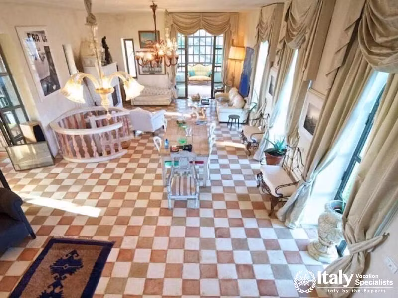 Spacious and elegantly decorated living room with a checkered floor.