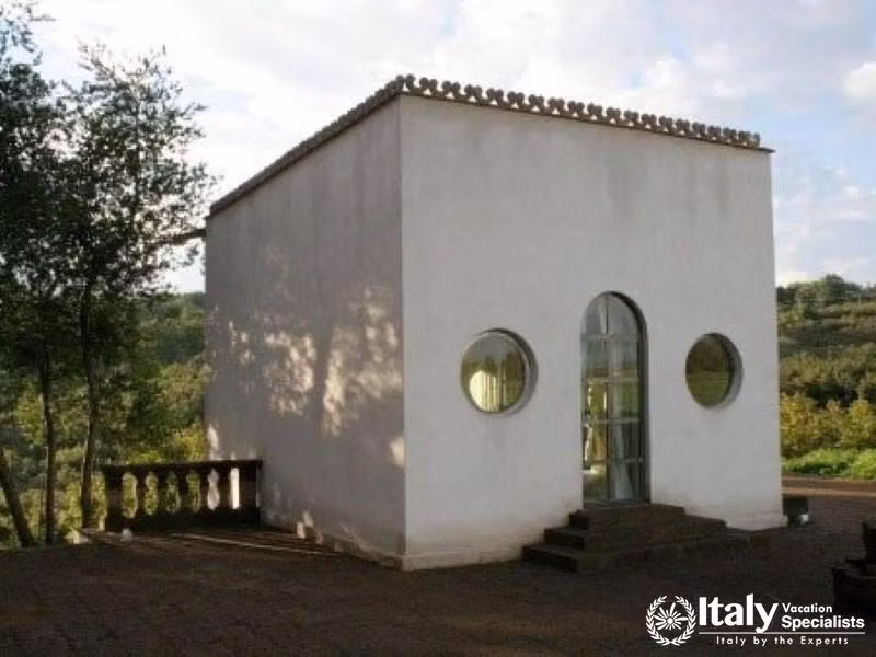 Minimalist white building with round windows.