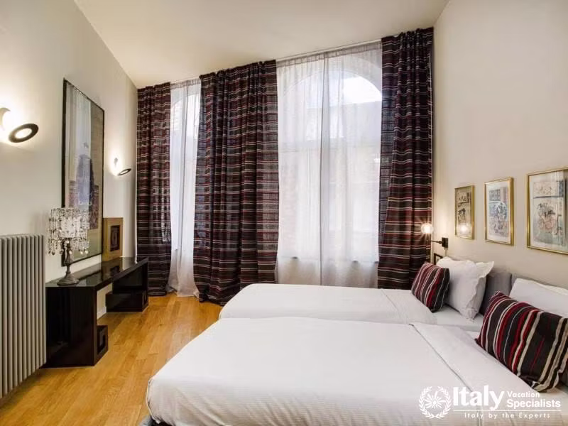 Serene twin bedroom with striped curtains and matching cushions.