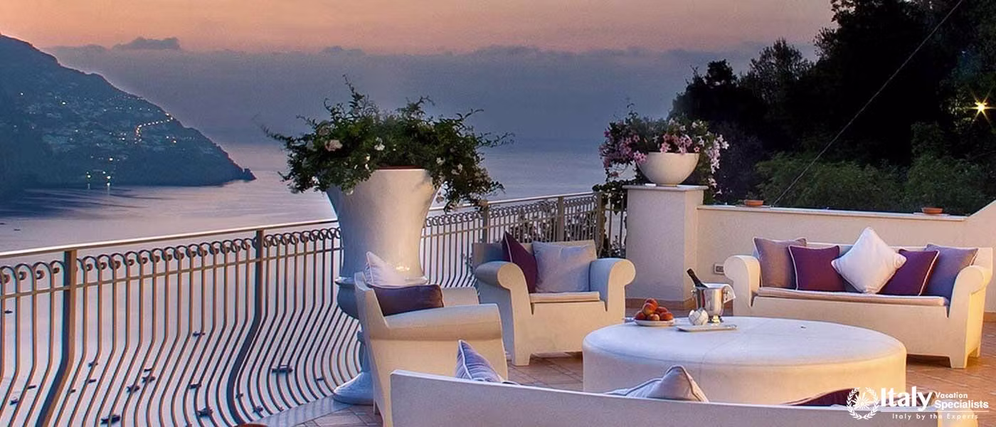 A cozy outdoor terrace setup, perfect for evening relaxation with a breathtaking sunset view.