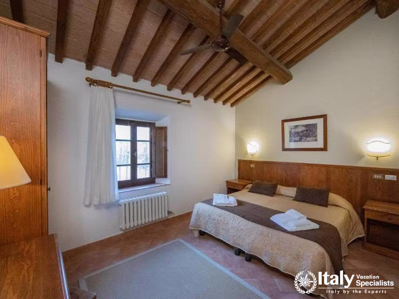 Comfortable Master Bedroom with Rustic Ceiling at La Dimora del Gazebo in San Gimignano, Italy
