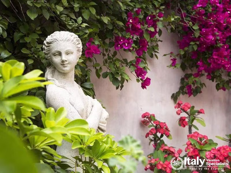 Villa Sontuosos Garden Statues Amidst Blooming Bougainvillea in Taormina