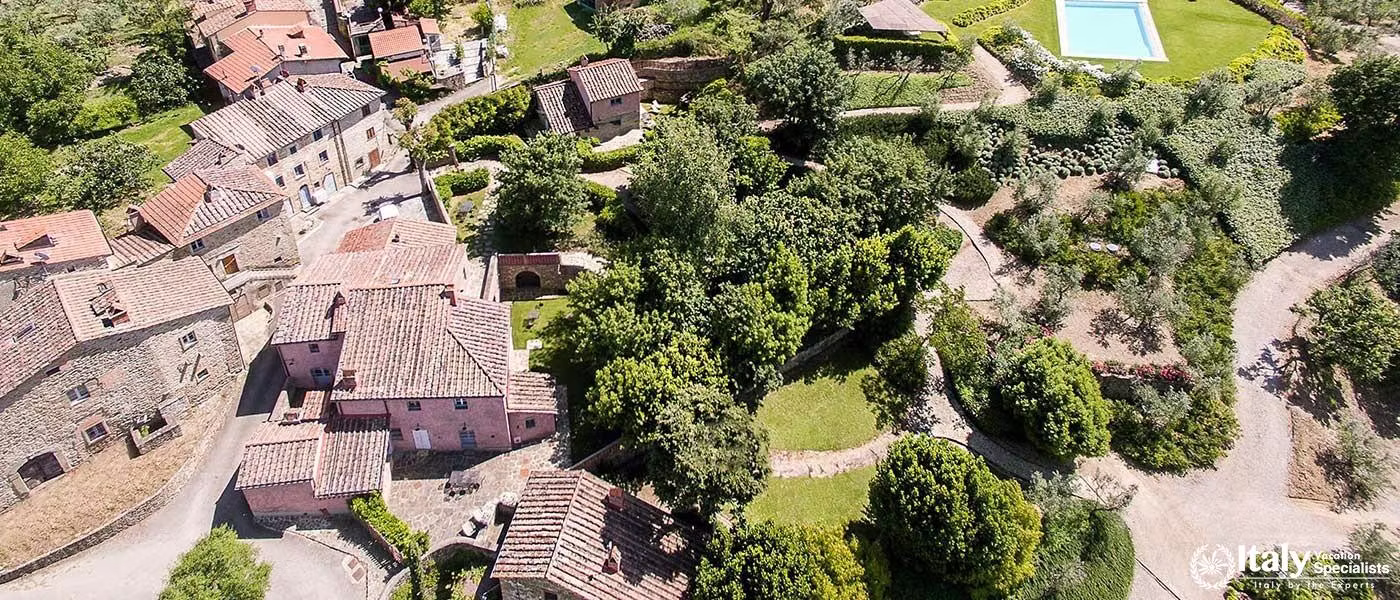 View of villa grounds with garden paths and buildings.