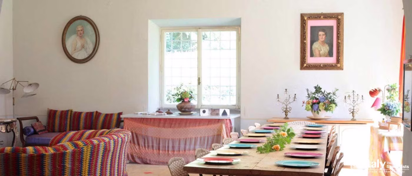 A vibrant dining room with a grand fireplace and colorful decor.