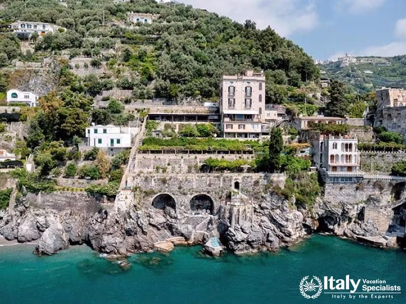 Villa with terraces, gardens, and direct sea access.
