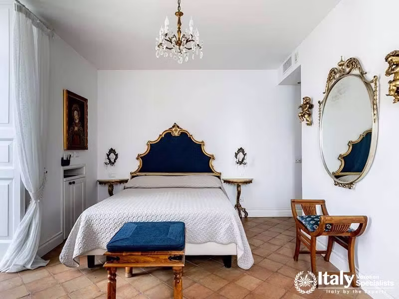 Luxurious Bedroom with Ornate Headboard and Vintage Mirrors - In Villa Dei Sogni in Amalfi Coast, It
