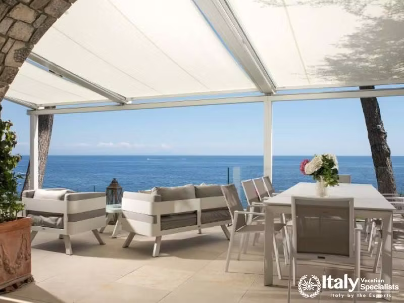 Spacious outdoor seating and dining area with ocean views.