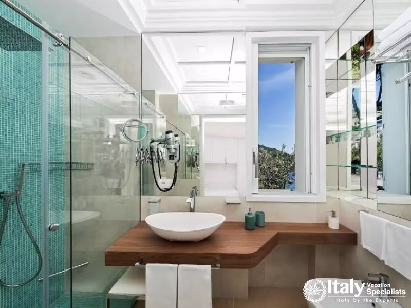 Elegant bathroom with a glass shower and a scenic window view.