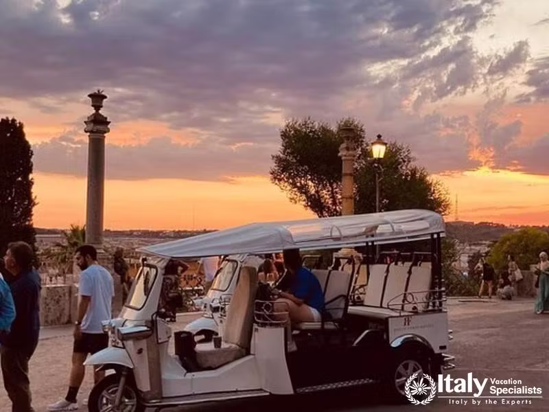 Enjoy a serene sunset ride through Rome in a charming golf cart.