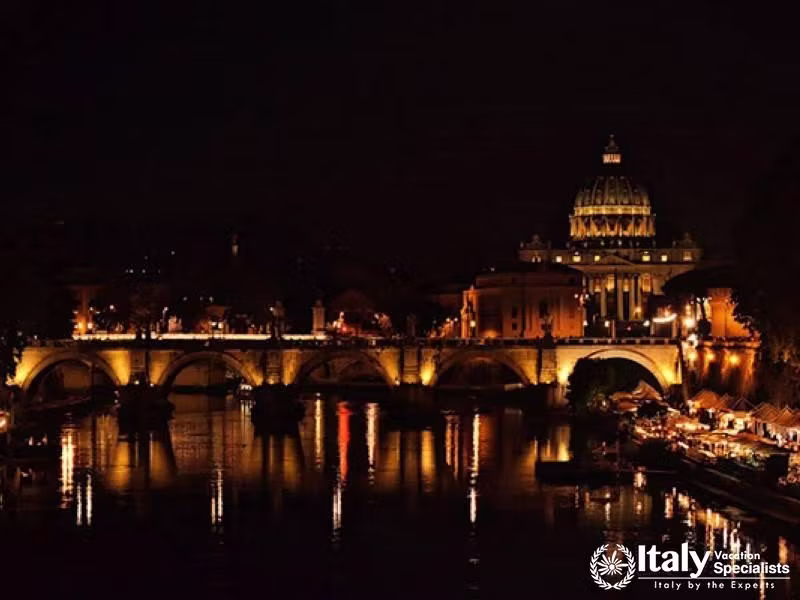 Admire the breathtaking night view of Romes bridges and basilicas.