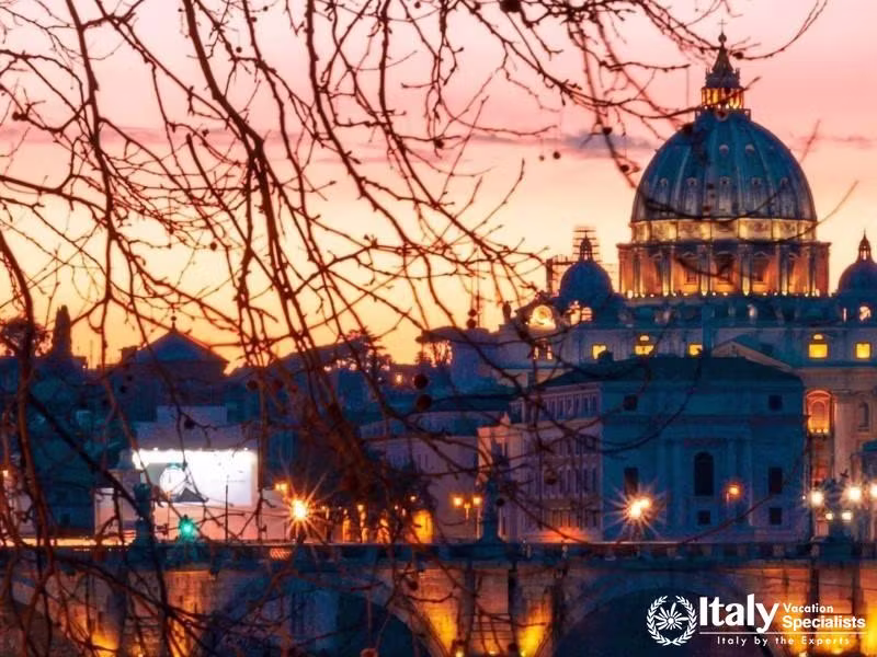 Admire the enchanting view of St. Peters Basilica as the sun sets.