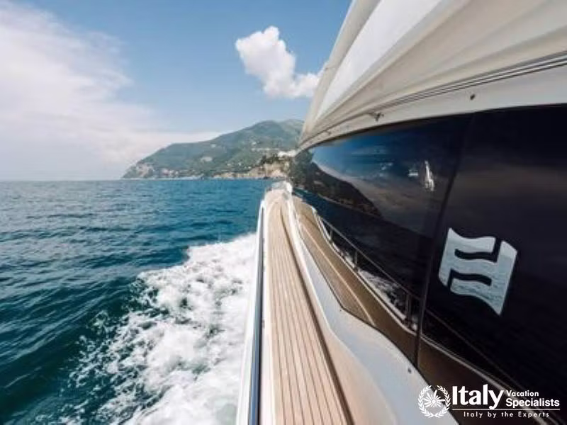The deck of a luxury yacht cruising along the coastline.