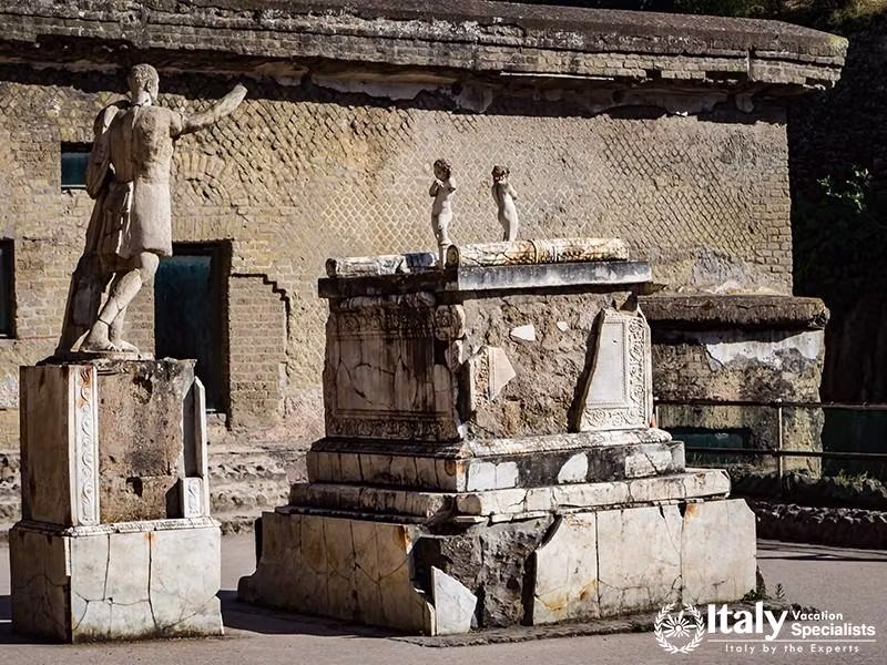 Herculaneum excavations, Ercolano, near Naples, Italy - June 3, 2018 -The marble altar and the statu