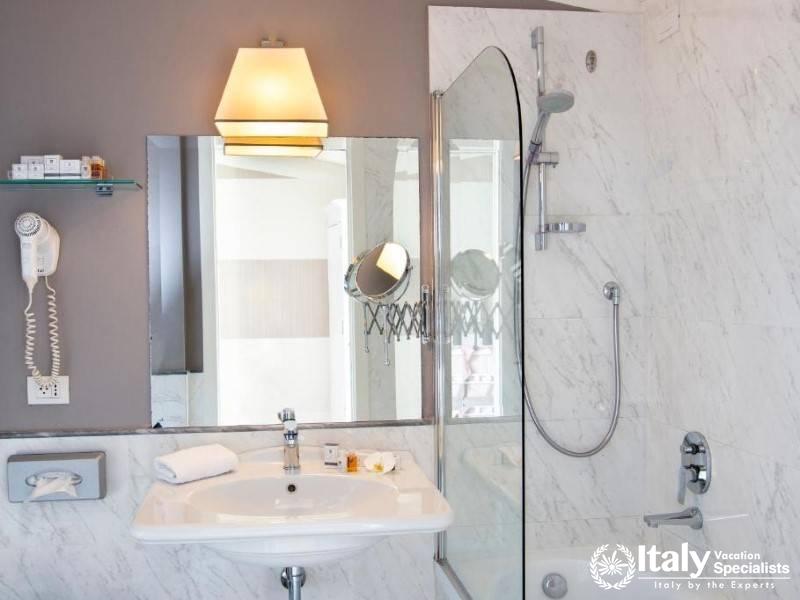 Chic Venetian Bathroom, Marble Elegance in Hotel Rapallo Florence