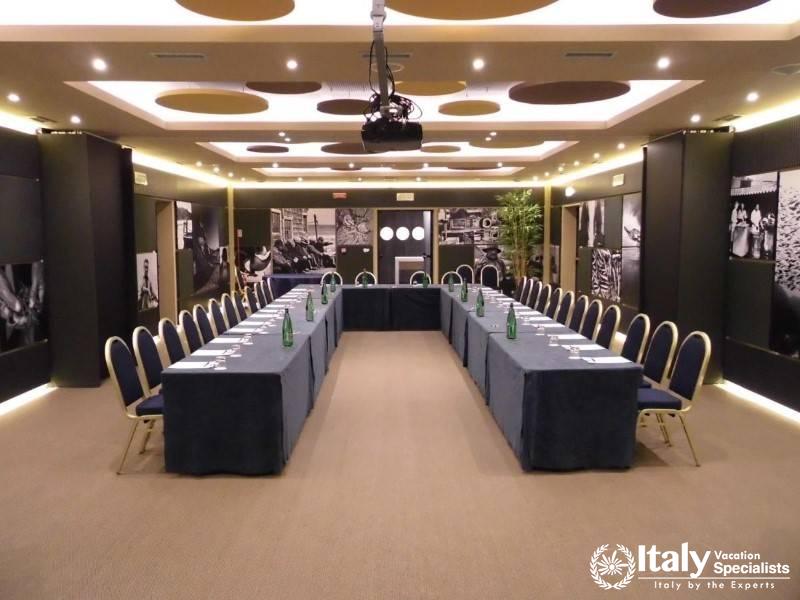 A spacious and well-equipped conference room with U-shaped seating.