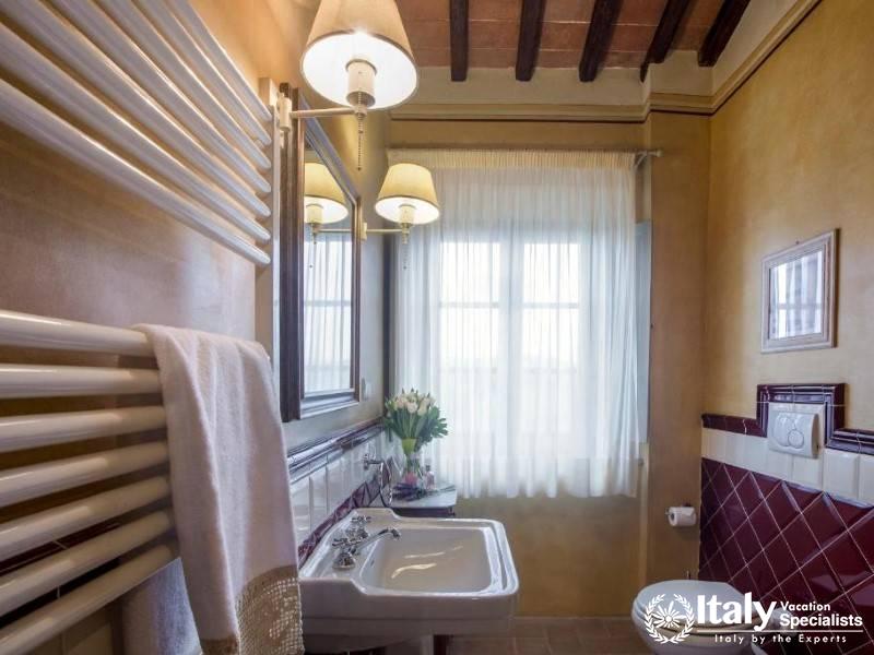 A charming bathroom featuring rustic elegance and modern amenities at Guardastelle Winery.
