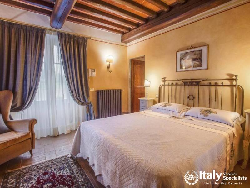 A cozy and inviting bedroom adorned with classic Tuscan decor and warm hues.