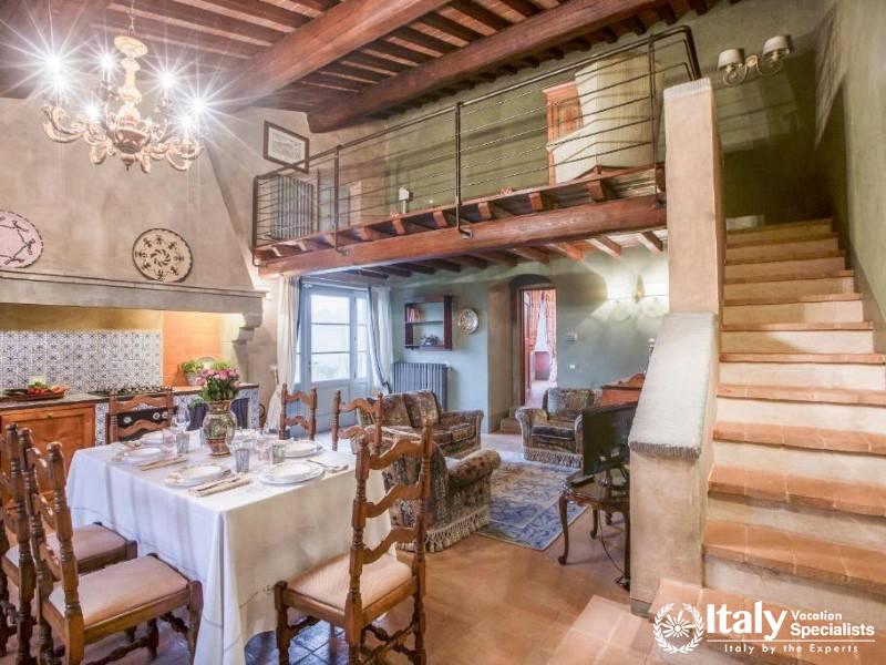 A grand dining and living area with a mezzanine, offering a luxurious and spacious environment.