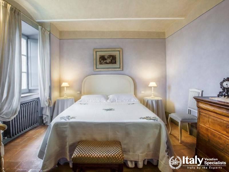 A serene and elegantly furnished bedroom offering comfort and a peaceful retreat.