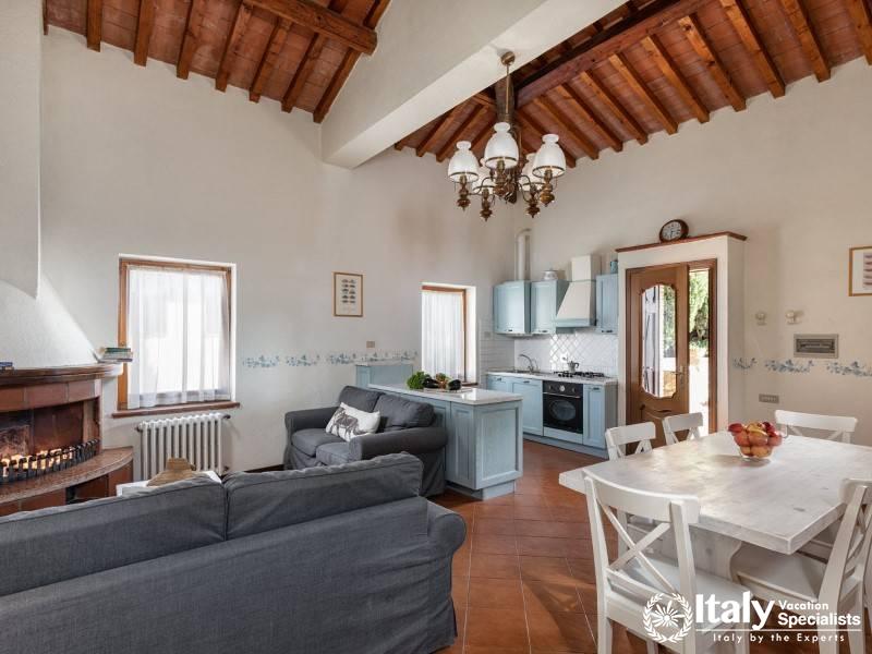 Relax in the open and inviting living area, featuring a fully equipped kitchen and cozy seating.