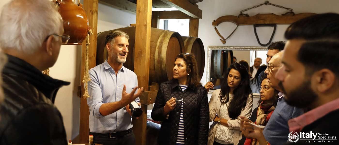 A passionate guide explains the winemaking process to visitors at Sant'Agnese Farm.