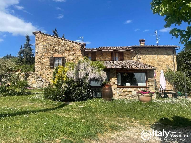 A charming stone farmhouse amidst lush gardens at SantAgnese Farm.