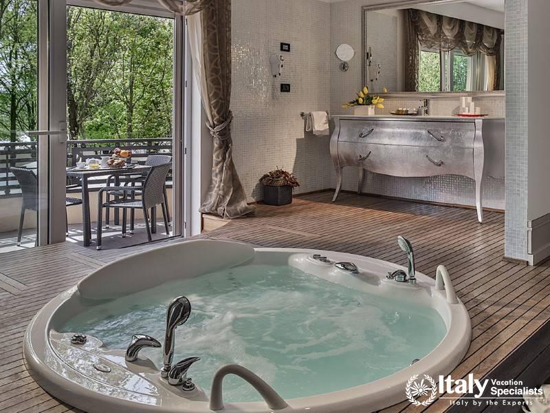 Indulge in a private, luxurious Jacuzzi with a serene view of the lush greenery.