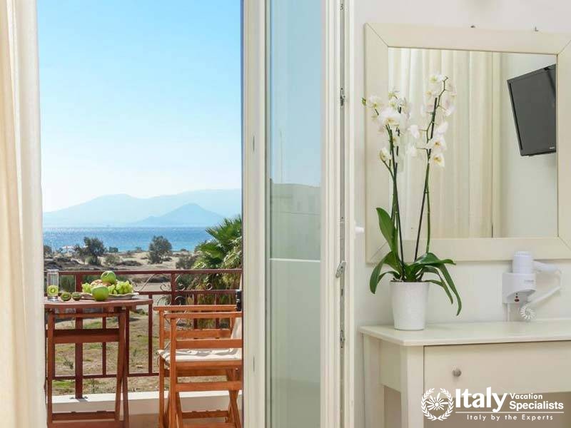 Beautiful balcony view with seating at Perla Hotel in Naxos, Greece Beautiful balcony view with seating at Perla Hotel in Naxos, Greece
