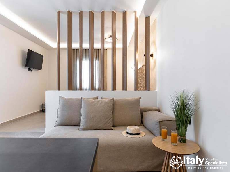 Cozy lounge area with a modern partition at Perla Hotel in Naxos, Greece Cozy lounge area with a modern partition at Perla Hotel in Naxos, Greece