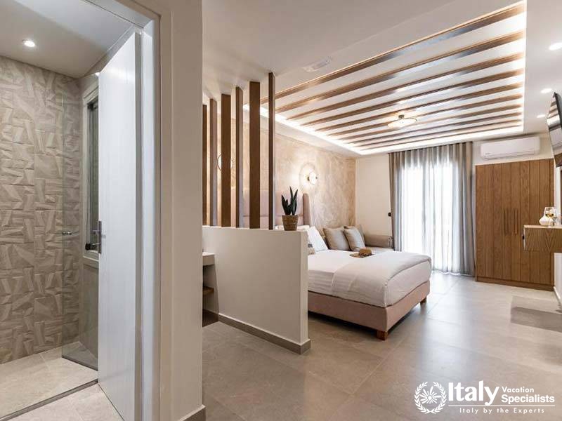 Elegant bedroom with stylish decor at Perla Hotel in Naxos, Greece Elegant bedroom with stylish decor at Perla Hotel in Naxos, Greece