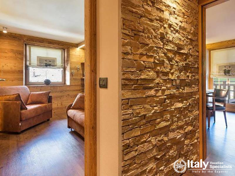 Stone Wall and Wooden Decor in Room in Bivio Hotel Plaza in Livigno, Italy