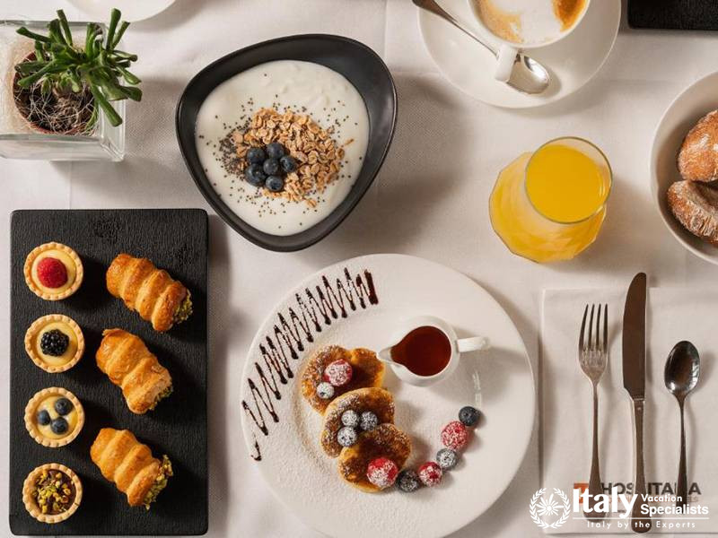 Delicious Breakfast Spread with Pastries and Fresh Fruits in Eden Hotel