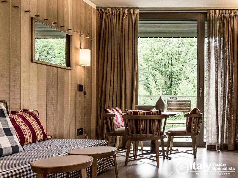 Cozy Living Room with Wooden Details and Balcony in Eden Hotel