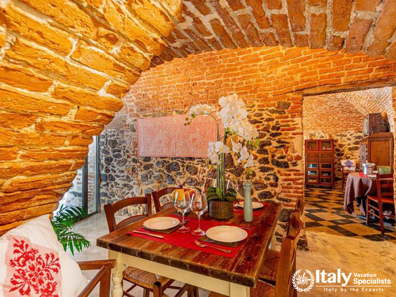 Cozy Dining Room with Brick Arch at Albergo Diffuso Mannois