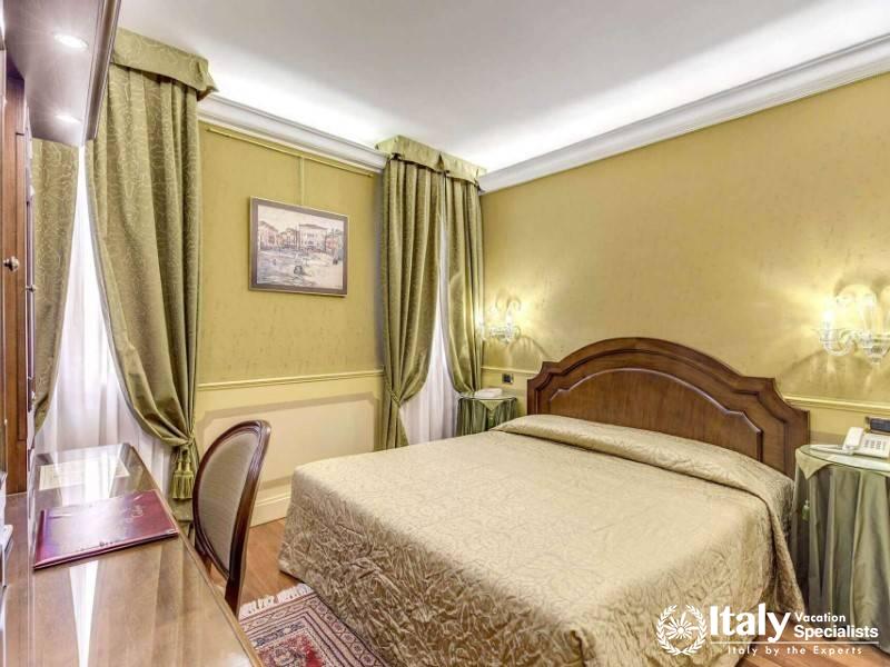 Classic Venetian elegance meets comfort in this double room at Hotel Al Codega.