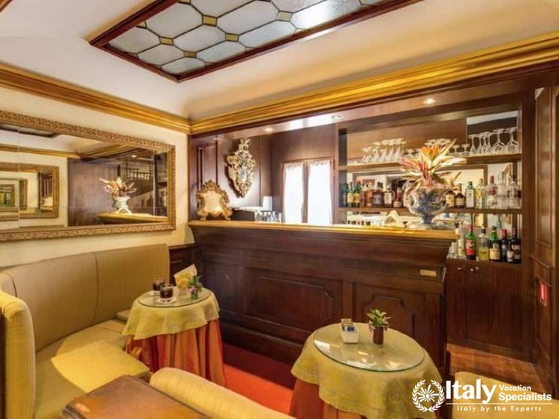 The intimate Hotel Al Codega lounge bar, with its sumptuous wood paneling and plush seating.