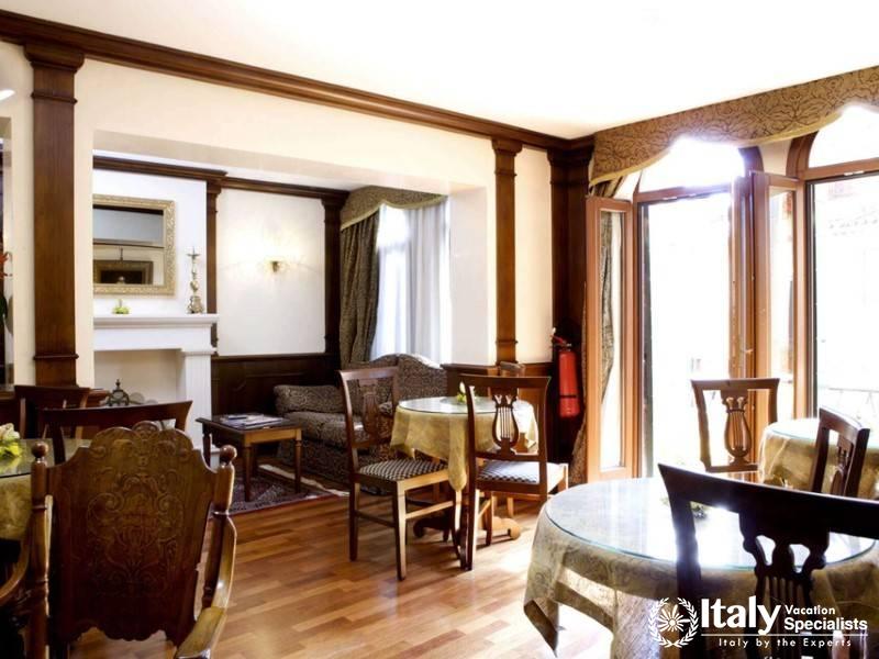 A warm and inviting common area within Hotel Al Codega, featuring elegant traditional dÃ©cor.