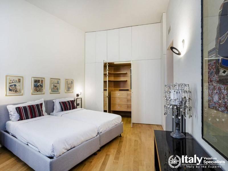 Twin bedroom with ample closet space and tasteful decor.