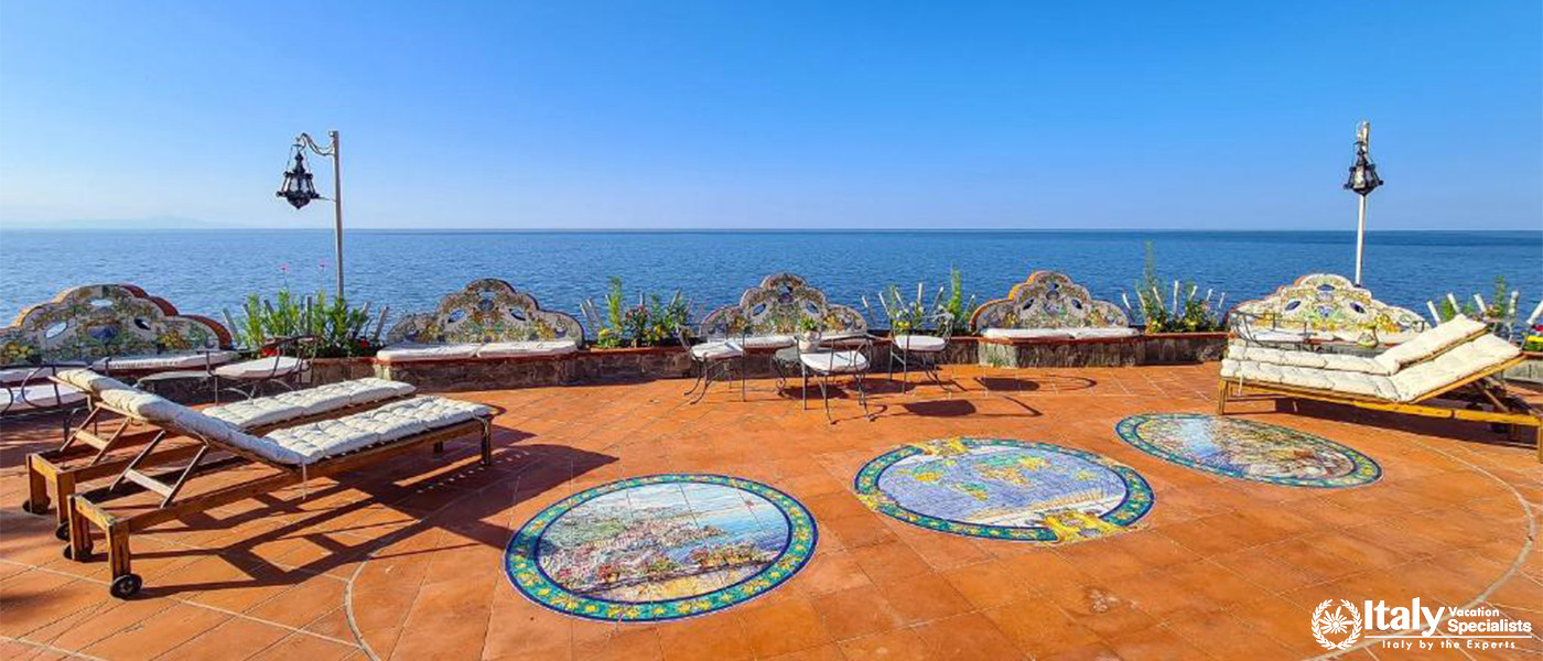 Seaside Terrace with Lounge Chairs in Villa Bellissima Vista Mare in Campania, Italy