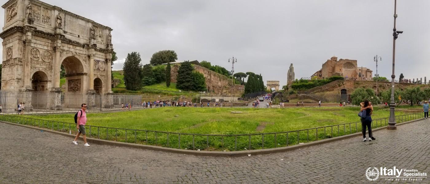 Rome, Italy - May 2018 Panoramic view of people exploring Roman Forum and Arco di Costantino in spri