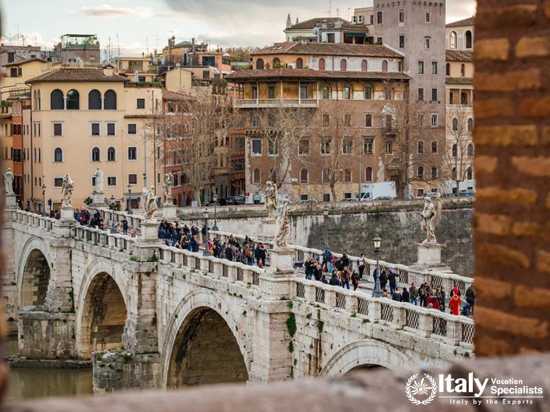 ROME, ITALY - FEBRUARY 4, 2018Tourists walking along SantAngelo Bridge (Holy Angel Bridge) in the h