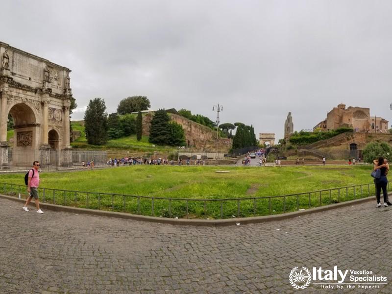 Rome, Italy - May 2018 Panoramic view of people exploring Roman Forum and Arco di Costantino in spri