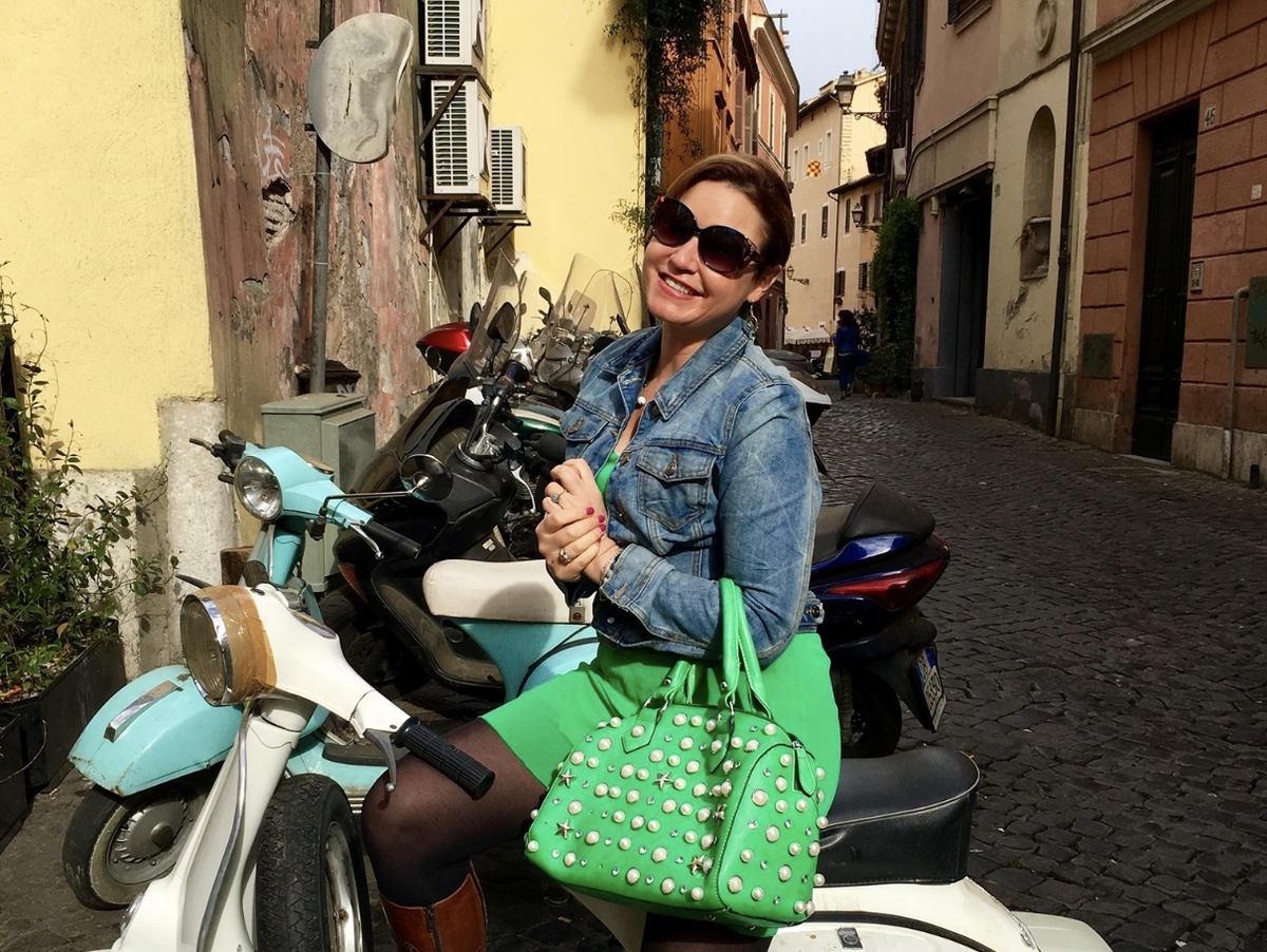 Jesse Andrews on a scooter in a cobbled street in Italy
