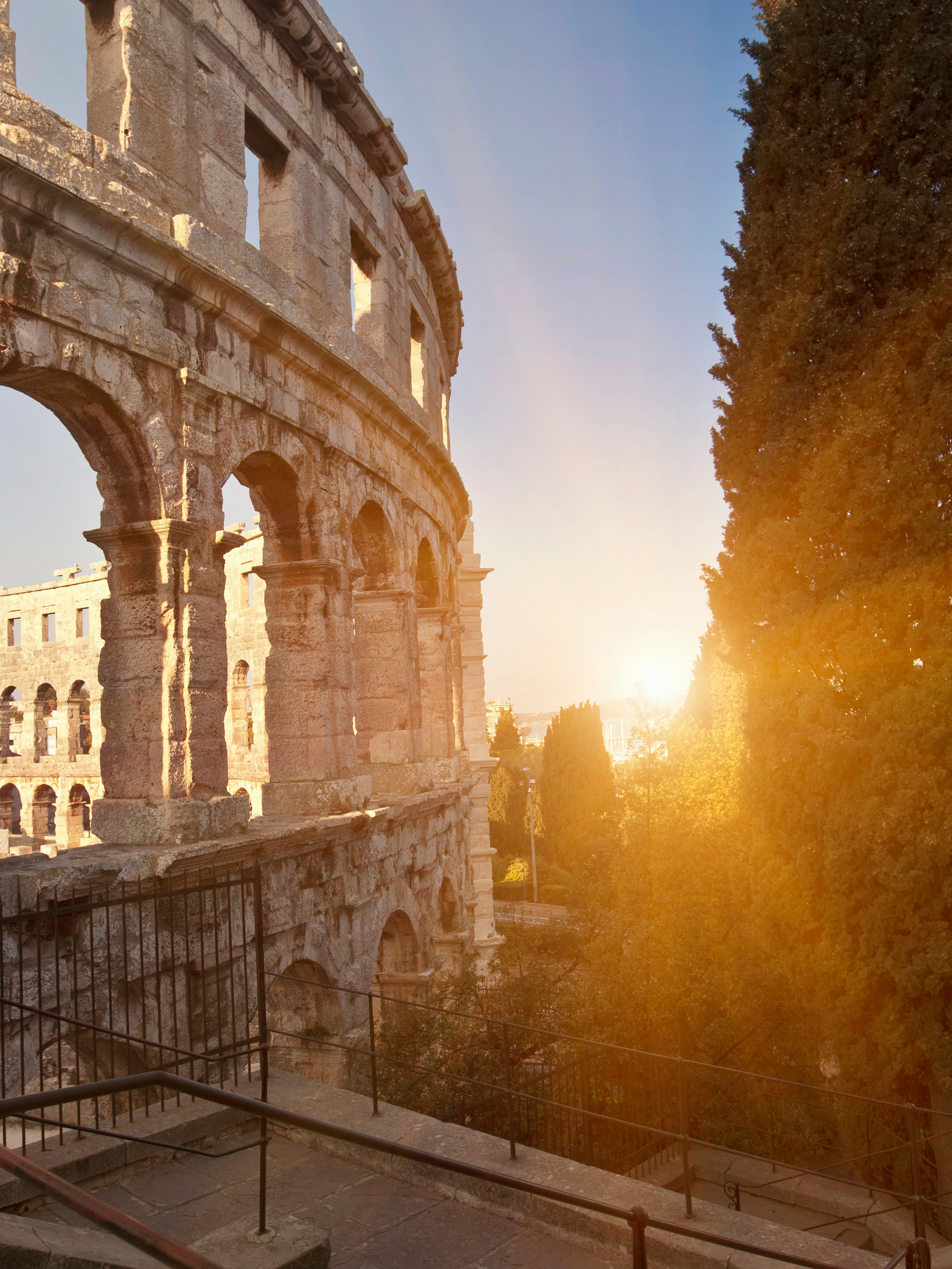 An ancient Roman amphitheater glowing in the morning sun