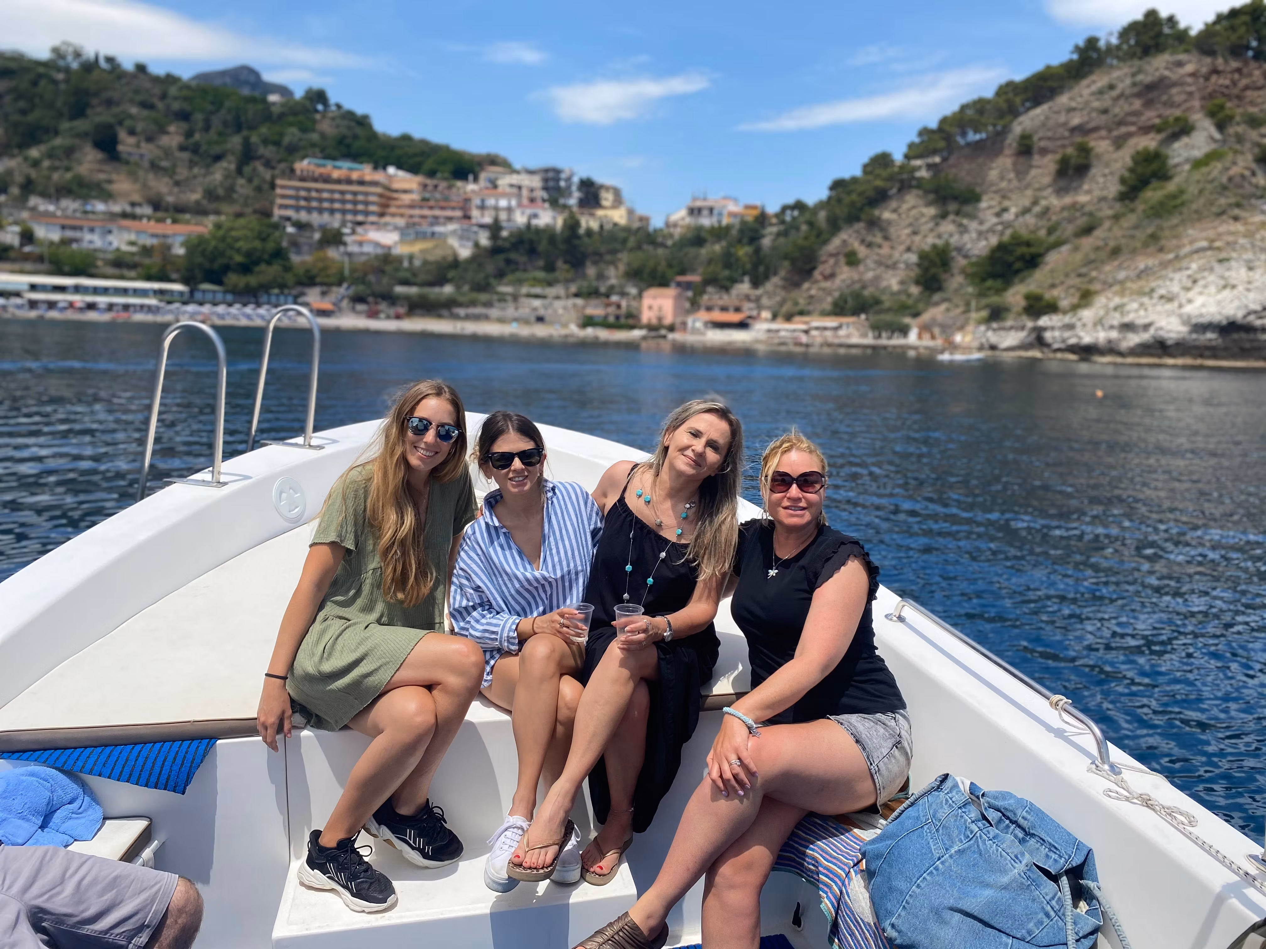 Four women on a boat off the Italian coast